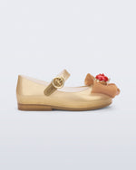 Side view of a beige Sweet Love Snow White baby flat with a beige bow with red apple center