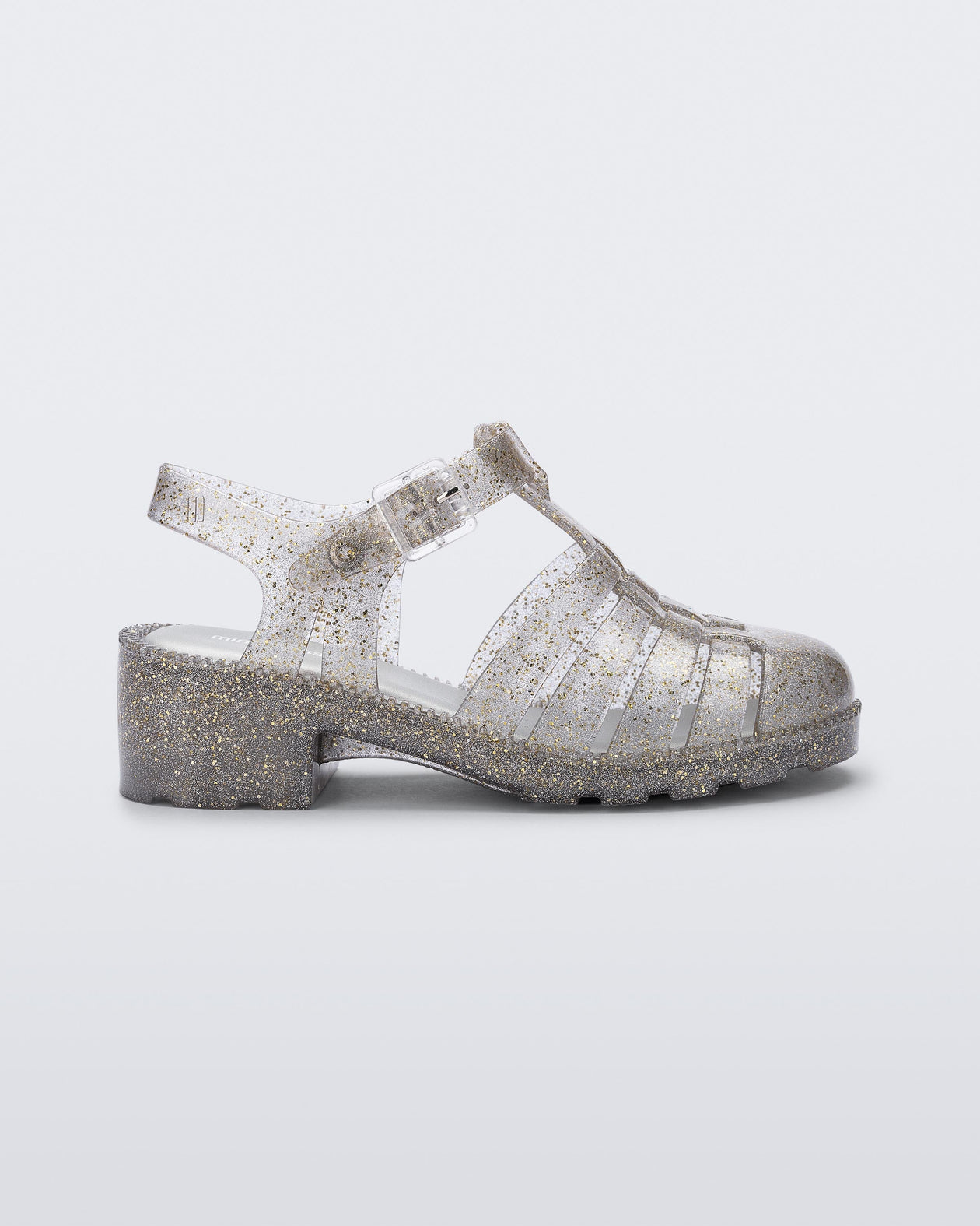 Side view of a clear glitter gold kids Possession Heel sandal