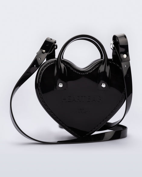 Back view of a black Heartbeat bag with small handles and longer strap.