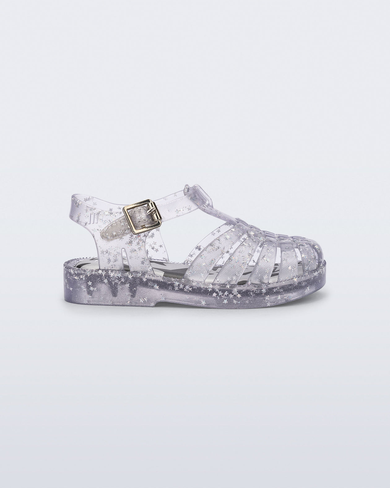 Side view of a clear Possession baby sandal with star glitter