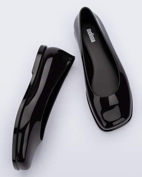 Side and top view of a pair of black Ruby adult flats.