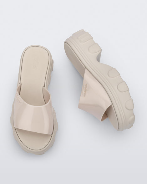 Side and top view of a pair of beige Ella slide platforms