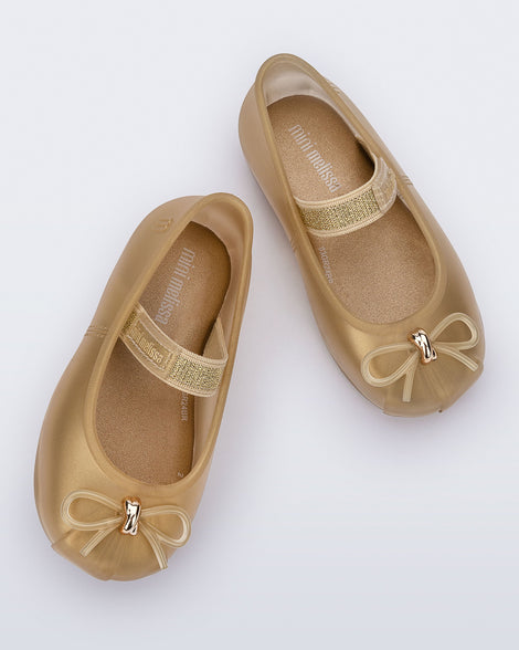 Top view of a pair of pearly beige Sophie baby ballerina flats with bow