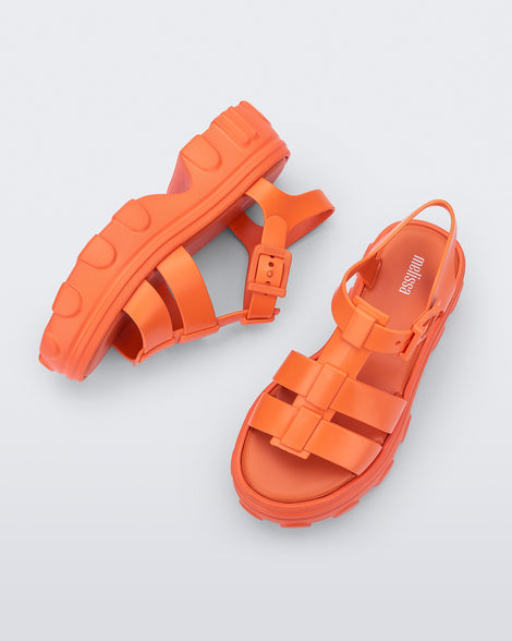 Side and top view of a pair of orange Ella platform adult sandals