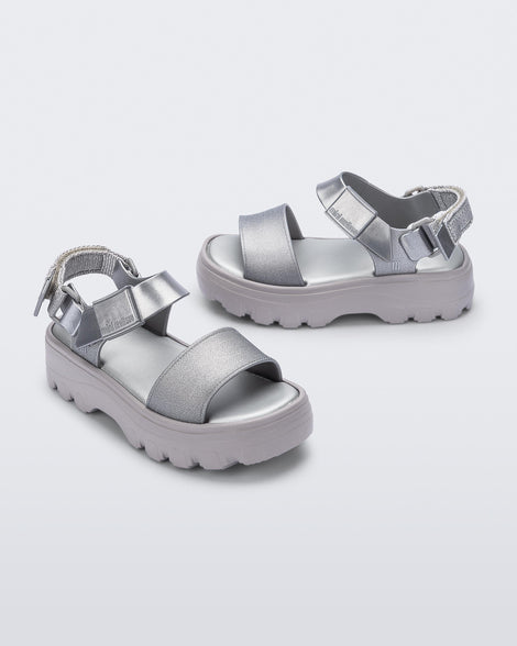 Angled view of a pair of silver kids Kick Off Sandals