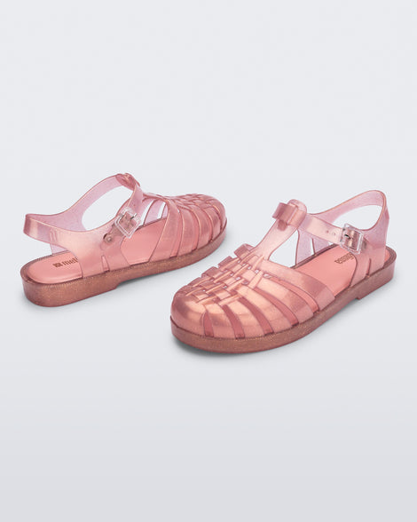 Top and angled view of a pair of pearly pink Possession sandals