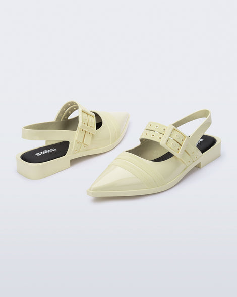 Angled view of a pair of beige Ladylike flats