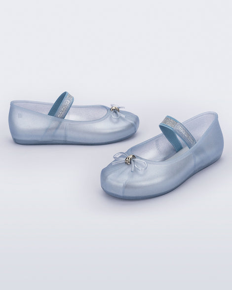 Side and angled view of a pair of pearly blue Sophie kids ballerina flats with bow