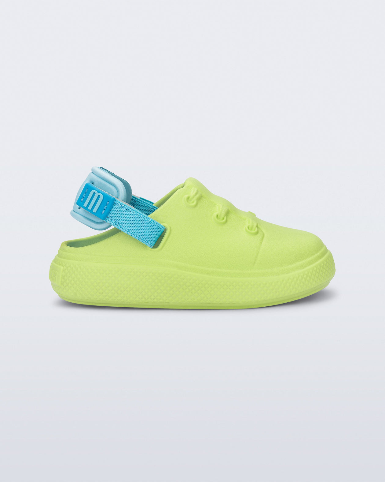 Side view of a green with blue back strap Charlie baby sneaker