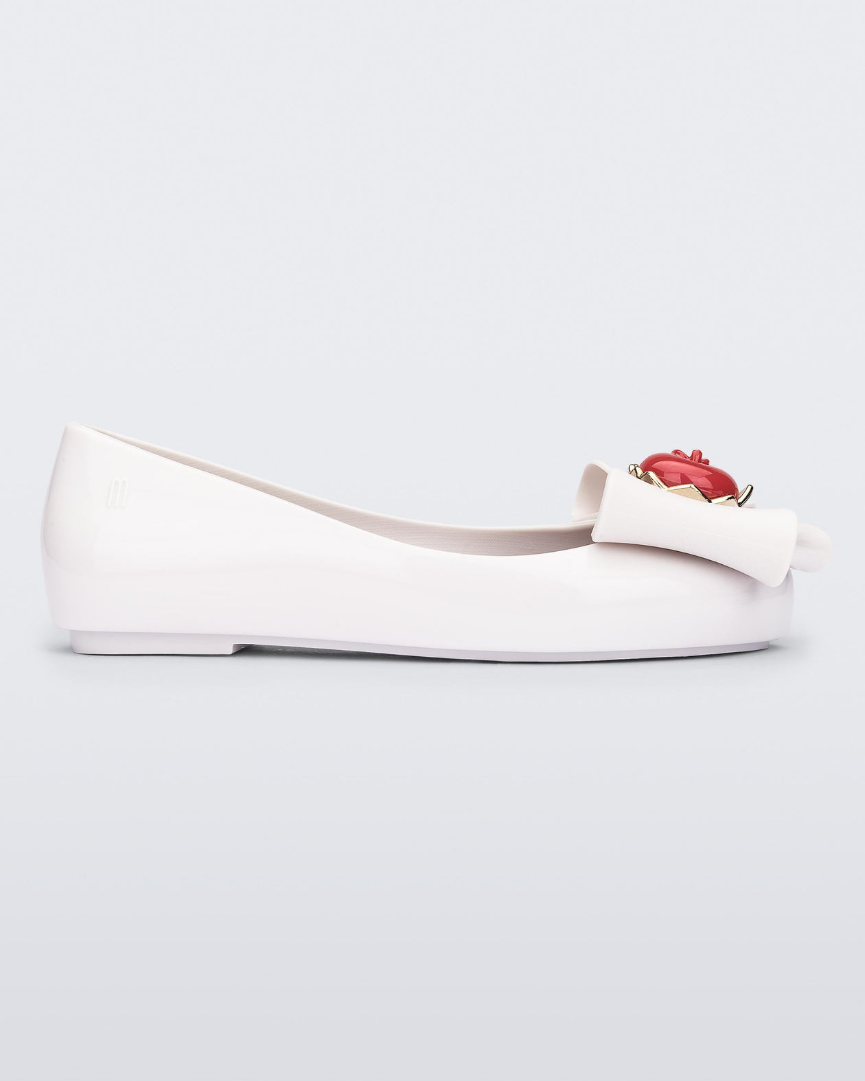 Side view of a white Sweet Love Snow White kids flat with a white bow with red apple center