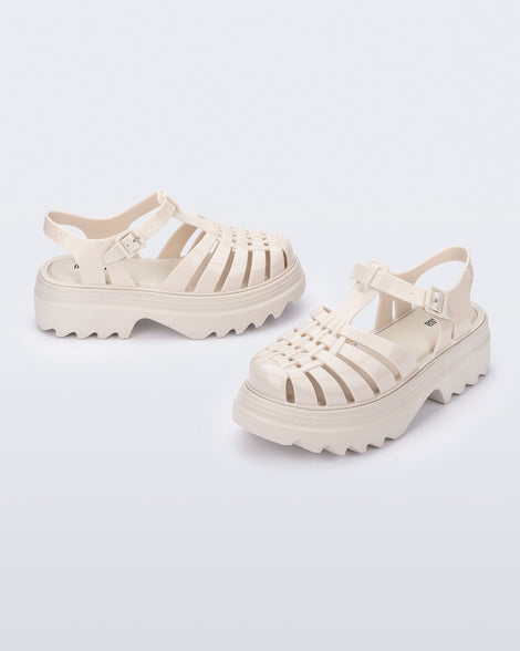 Side and angled view of a pair of beige Possession Platform II sandals.