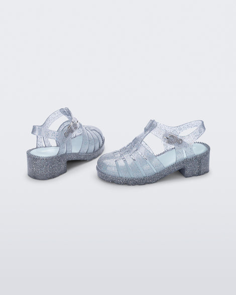 Back and side view of a pair of clear glitter kids Possession Heel sandals