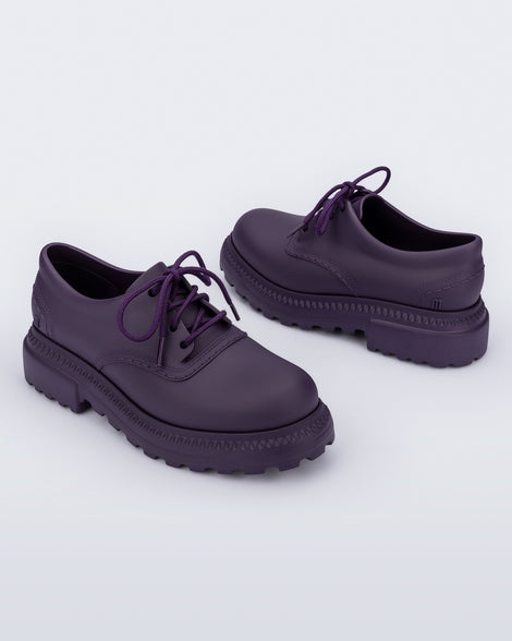 Angled view of a pair of matte purple Charlotte adult sneaker loafers with laces