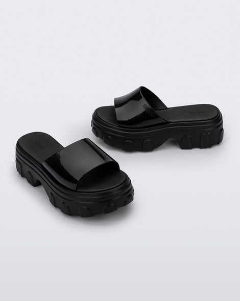 Side and angled view of a pair of black Ella slide platforms