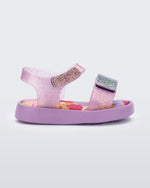 Side view of a glitter lilac baby Jump sandal