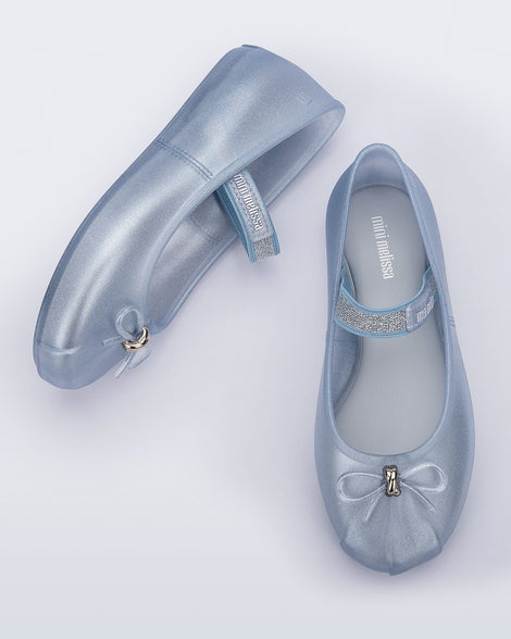 Side and top view of a pair of pearly blue Sophie kids ballerina flats with bow