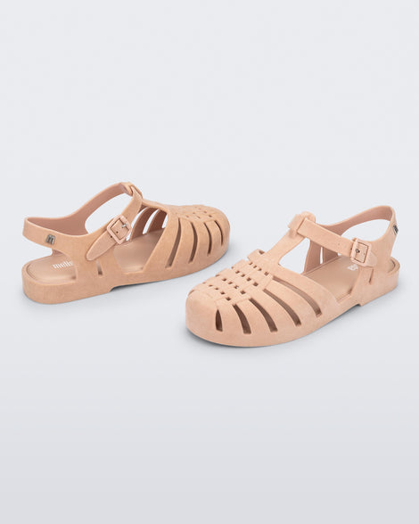 Side and angled view of a pair of light pink Possession Velvet sandals.