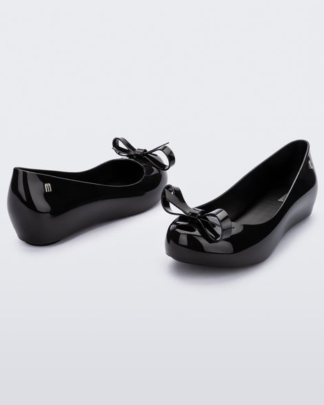 Angled view of a pair of black Ultragirl Bow flat