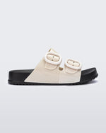 Side view of a kids beige Cozy slide with black sole