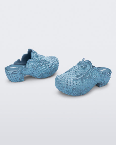 Angled side view of a pair of blue Court Clog + Y/Project platform clogs