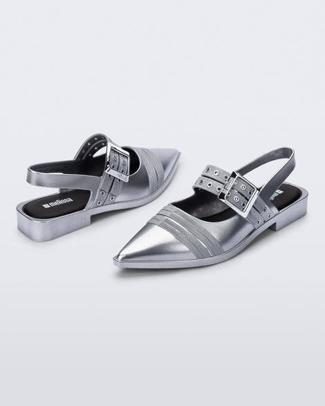 Angled view of a pair of silver Ladylike flats