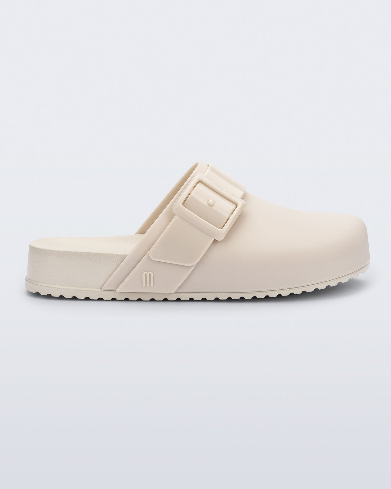 Side view of an adult beige Cozy Clog.