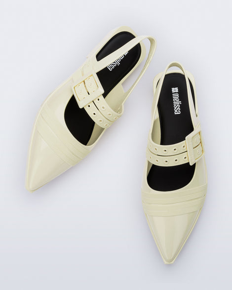 Angled and top view of a pair of beige Ladylike flats