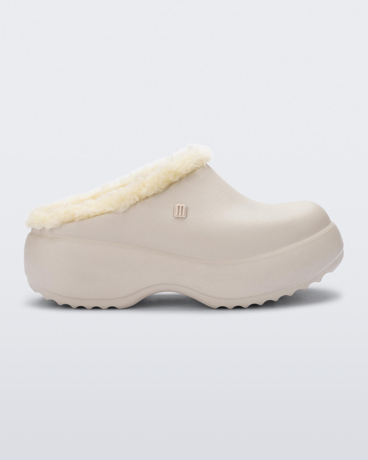 Side view of a beige Free Clog Fluffy Platform with light beige fluffy liner