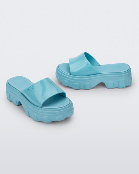 Side and angled view of a pair of blue Ella slide platforms