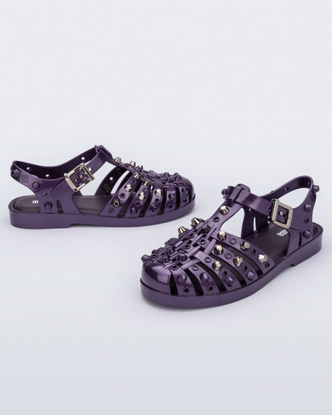 Side and angled view of a pair of purple Possession Studs fisherman sandals with silver studs.