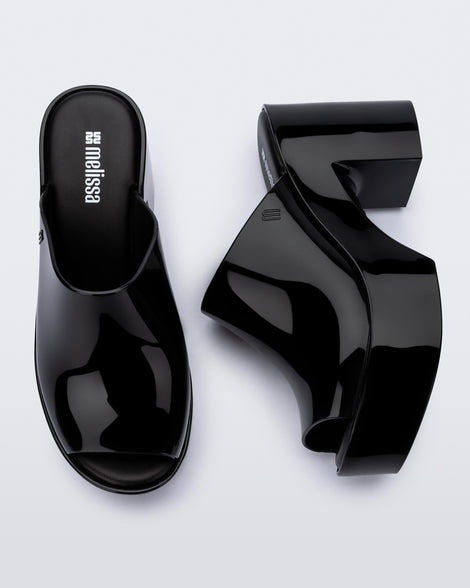 Top and side view of a pair of black Mule Hype heel platforms