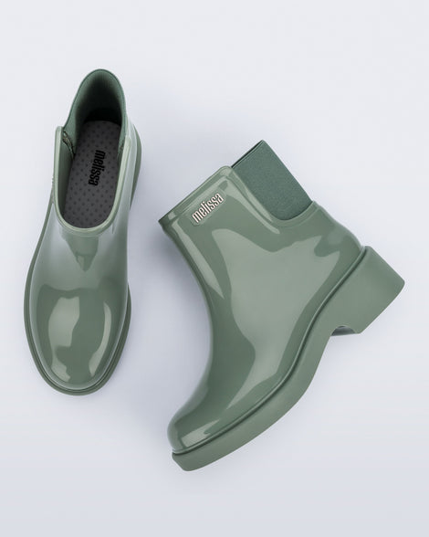 Top and side view of a pair of sage green Chelsea Boots.