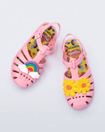 Top view of a matte pink kids Possession + Play Doh sandal with one shoe having a daisy and the other a rainbow on the upper