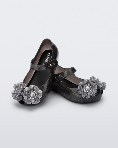 Angled view of a pair of glitter black baby Ultragirl Springtime flats