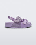 Side view of a lilac glitter Mini Melissa Cozy sandal with with two front straps with buckle detail