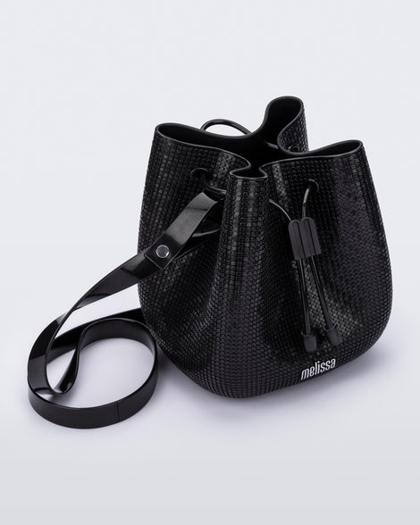 Angled view of a black Lux bucket bag with drawstring and strap