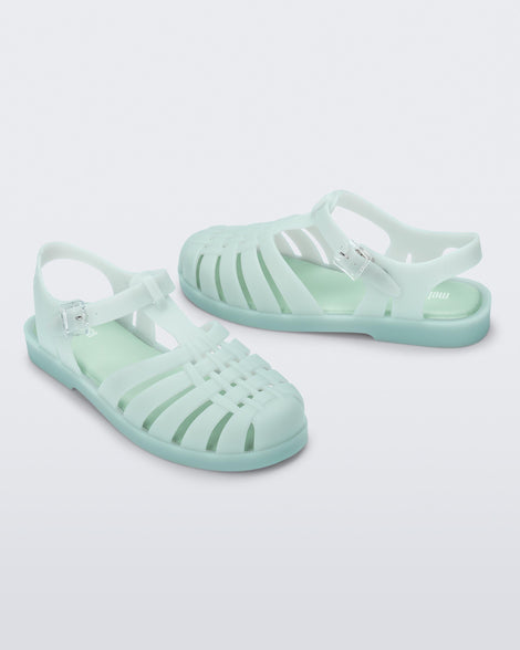 Side angled view of a pair of light green Possession sandals