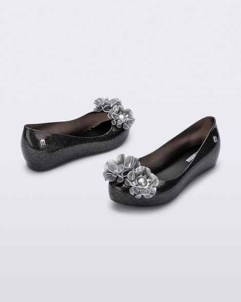 Angled view of a pair of glitter black kids Ultragirl Springtime flats