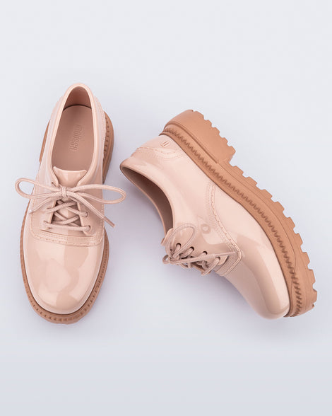 Top and side view of a pair of pink with brown sole Charlotte adult sneaker loafers with laces