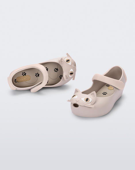 Top and angled view of a pair of beige baby Ultragirl Cat flats