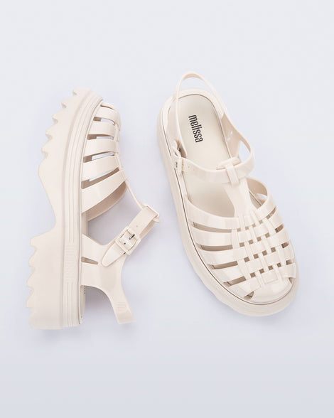 Side and top view of a pair of beige Possession Platform II sandals.