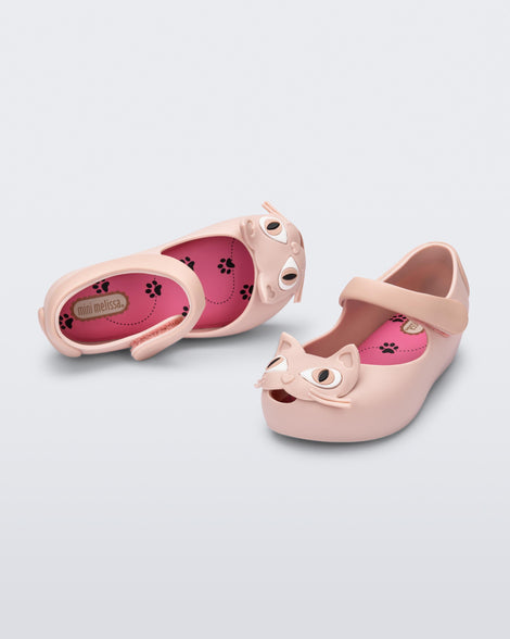 Top and angled view of a pair of light pink baby Ultragirl Cat flats