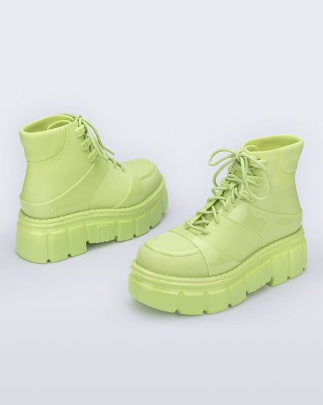 Back and side angled view of a pair of green Rebel Boots with laces