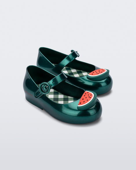 Angled view of a pair of green Sweet Love Picnic baby flats with watermelon slices