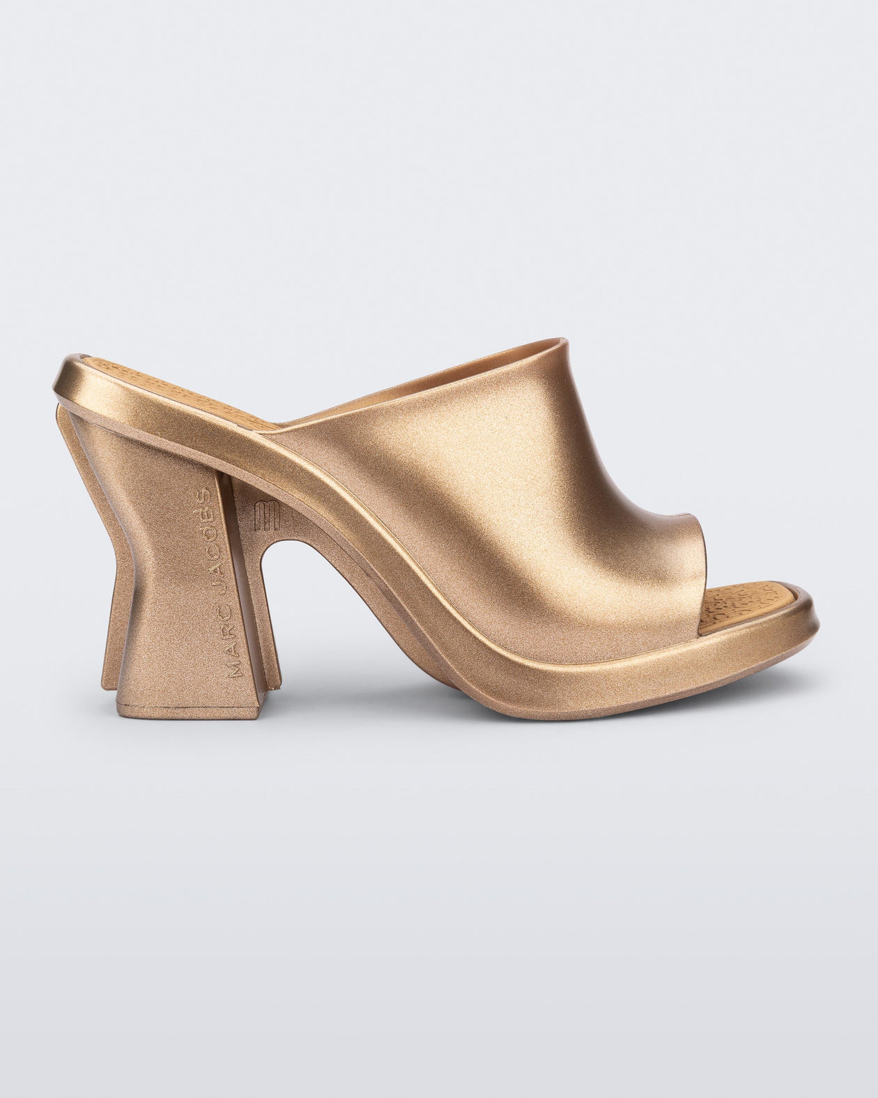 Side view of a gold Mule + Marc Jacobs heel