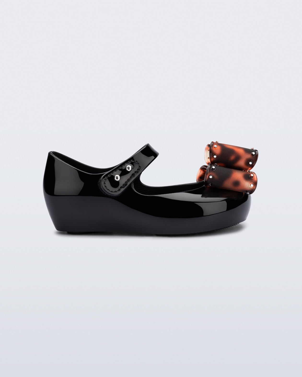 Side view of a black baby Ultragirl Classic Bow flats with tortoise bow