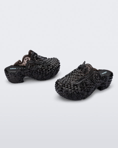 Angled side view of a pair of black Court Clog + Y/Project platform clogs