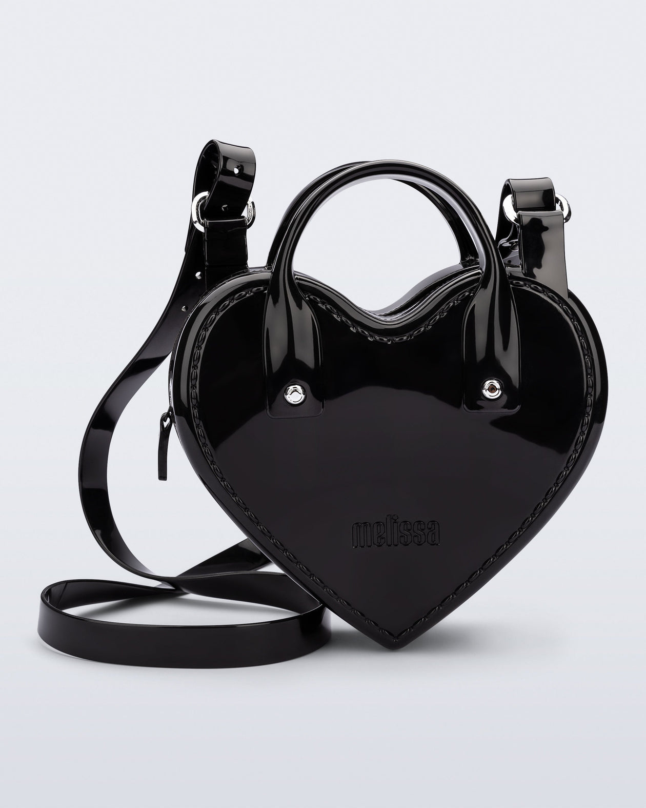 Front view of a black Heartbeat bag with small handles and longer strap.