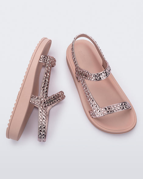 Side and top view of a pair of pink Lust sandals with rose gold strap