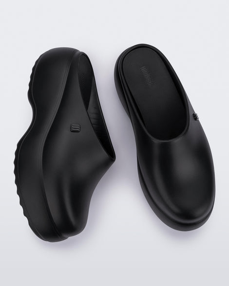 Side and top view of a pair of black Free Clog Platforms